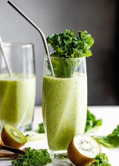 two tall drinking glasses with green smoothie