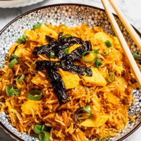 Image of kimchi fried rice served in bowls with chopsticks.