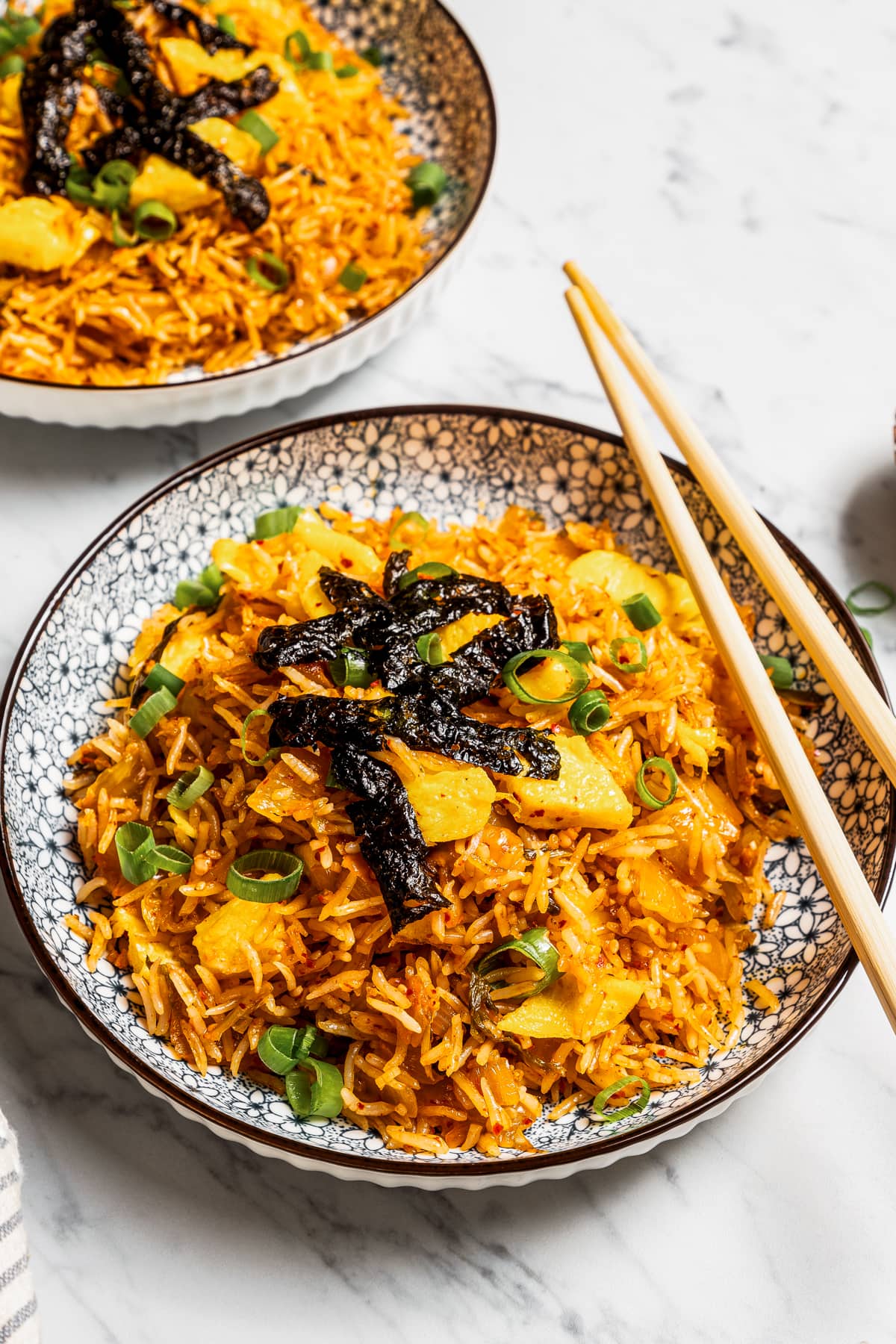 Kimchi fried rice served in a bowl with chopsticks.