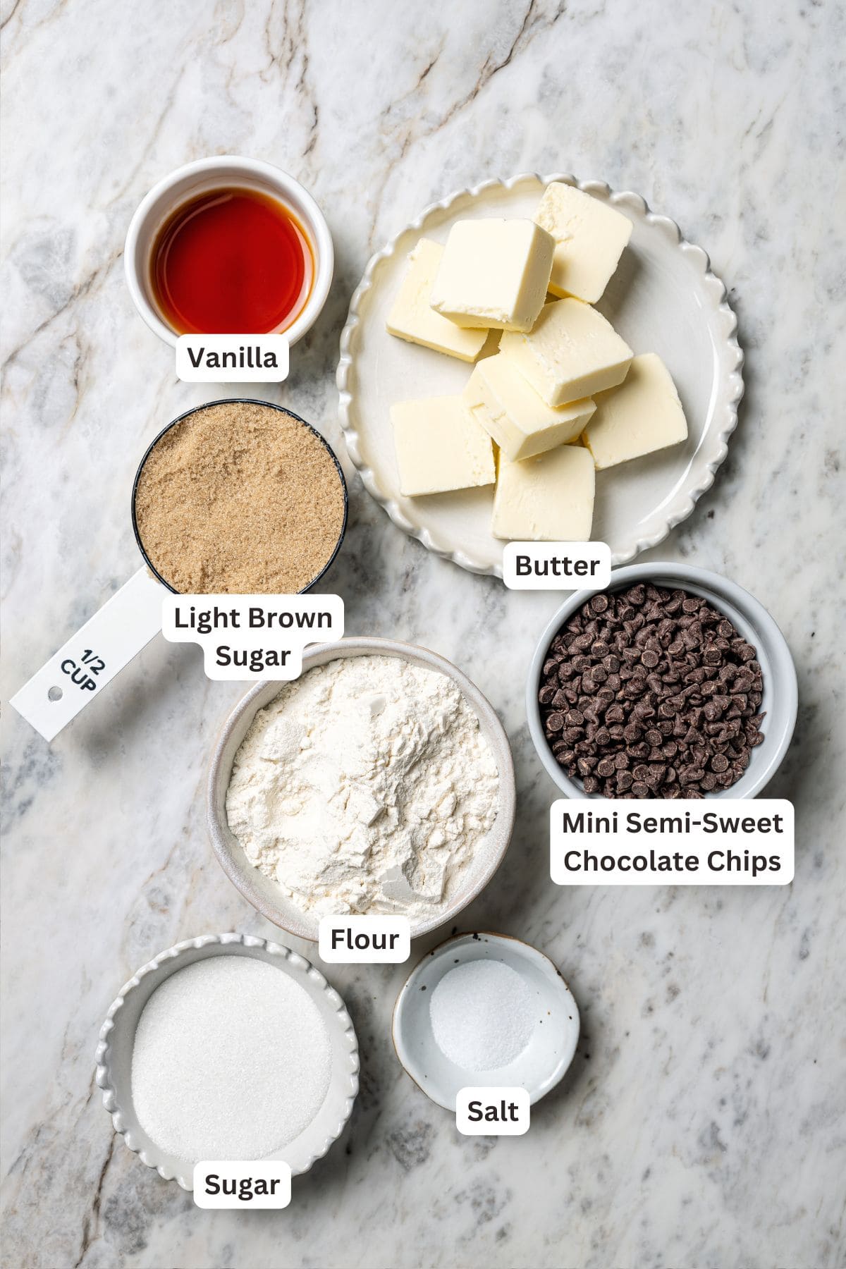 This chocolate chip cookie dough ice cream combines creamy homemade vanilla ice cream with irresistible chunks of buttery cookie dough. Cookie dough ingredients with text labels overlaying each ingredient.