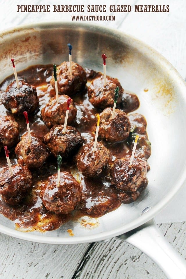 Glazed Meatballs with toothpicks in them in a frying pan