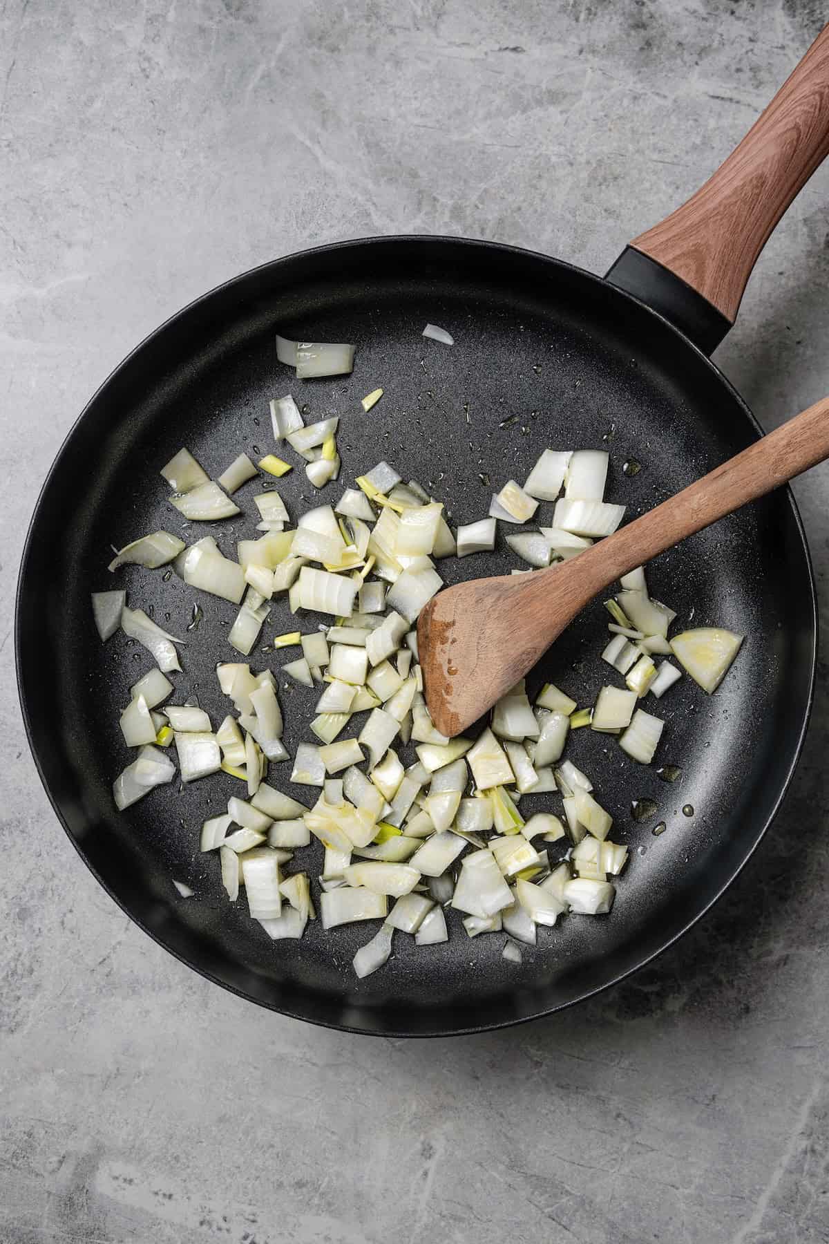 This easy rhubarb chutney is the best way to use fresh rhubarb! It’s sweet and tangy with warm spice, and delicious with just about anything! Onions sautéing in a skillet.