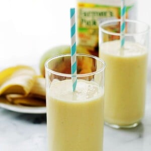 Two glasses of banana mango smoothies.