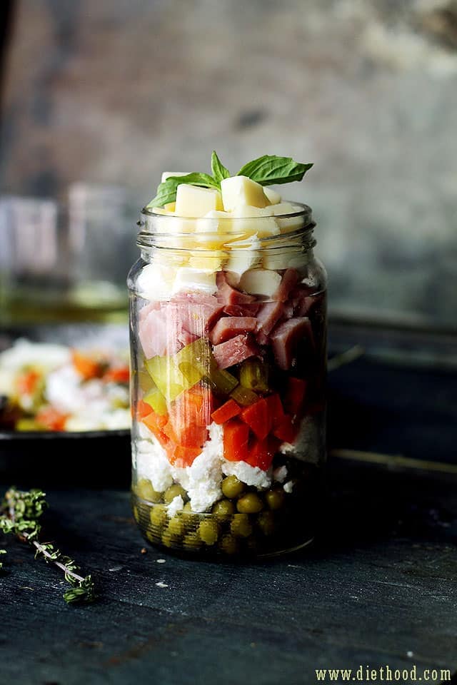 Russian Layered Salad | www.diethood.com | Russian Layered Salad is a delicious salad recipe made with ham, eggs, cheeses, carrots, peas, and pickles. | #recipes #memorialday #salad #russiansalad