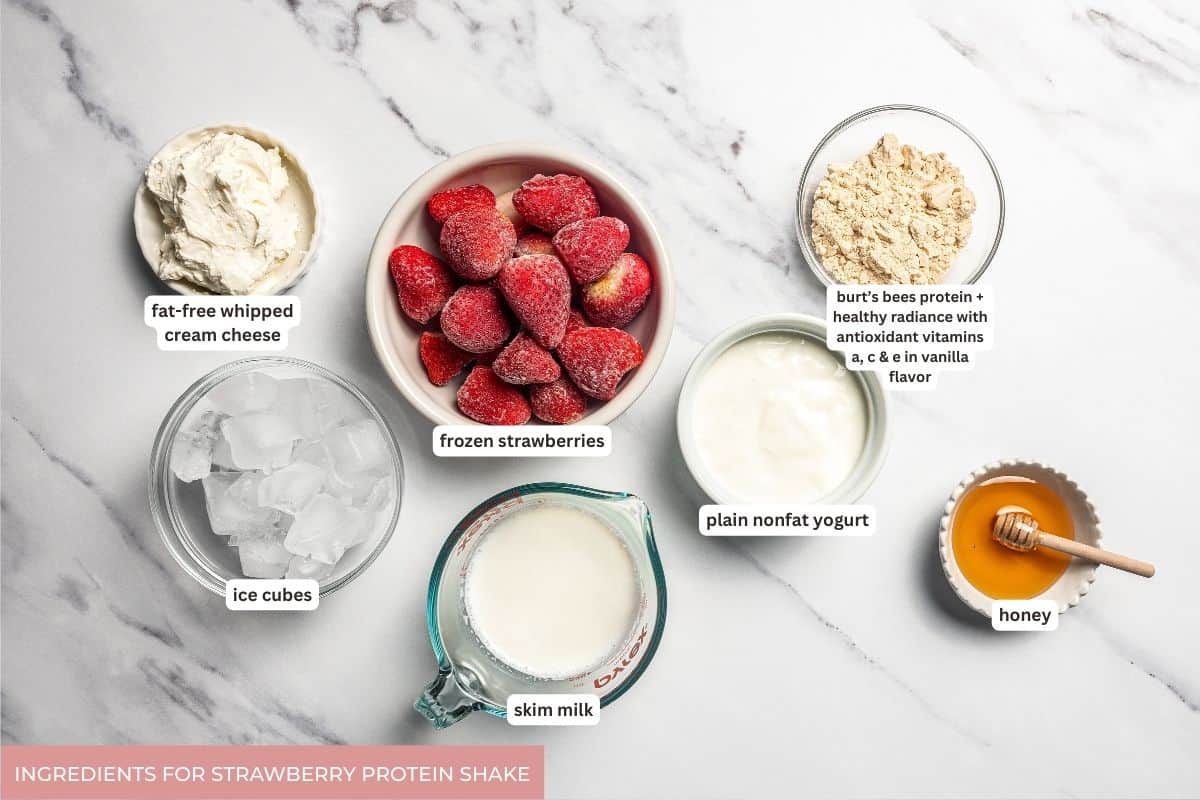 Strawberry protein shake ingredients with text labels overlaying each ingredient.