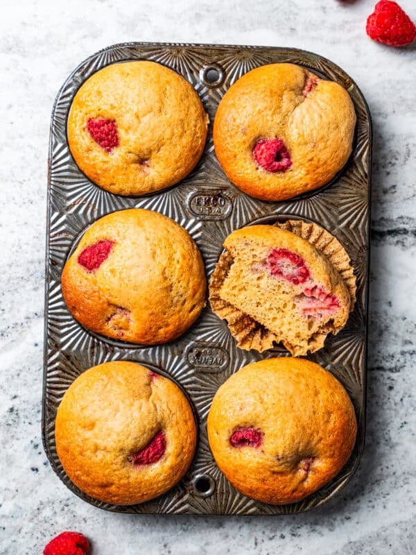 Raspberry muffins in a muffin pan.