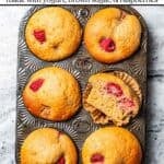 Raspberry muffins in a muffin tin with text overlay of the recipe's title.