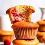 Stacked up raspberry muffins text overlay of the recipe's title.