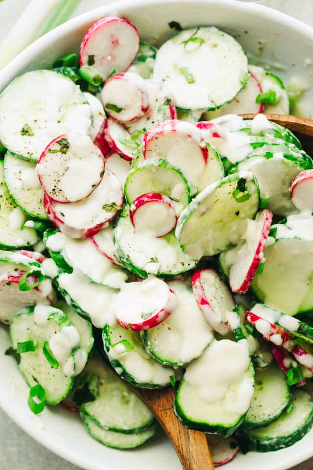 Radish and Cucumber Salad with Garlic-Yogurt Dressing in a white salad bowl