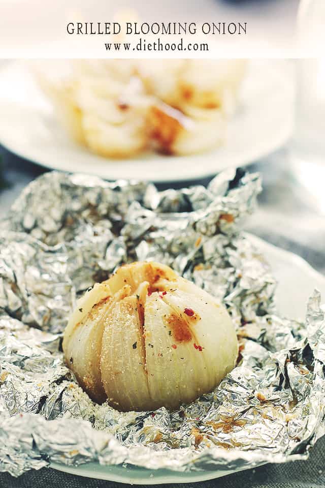 Grilled Blooming Onion set on a piece of foil and drizzled with steak sauce.