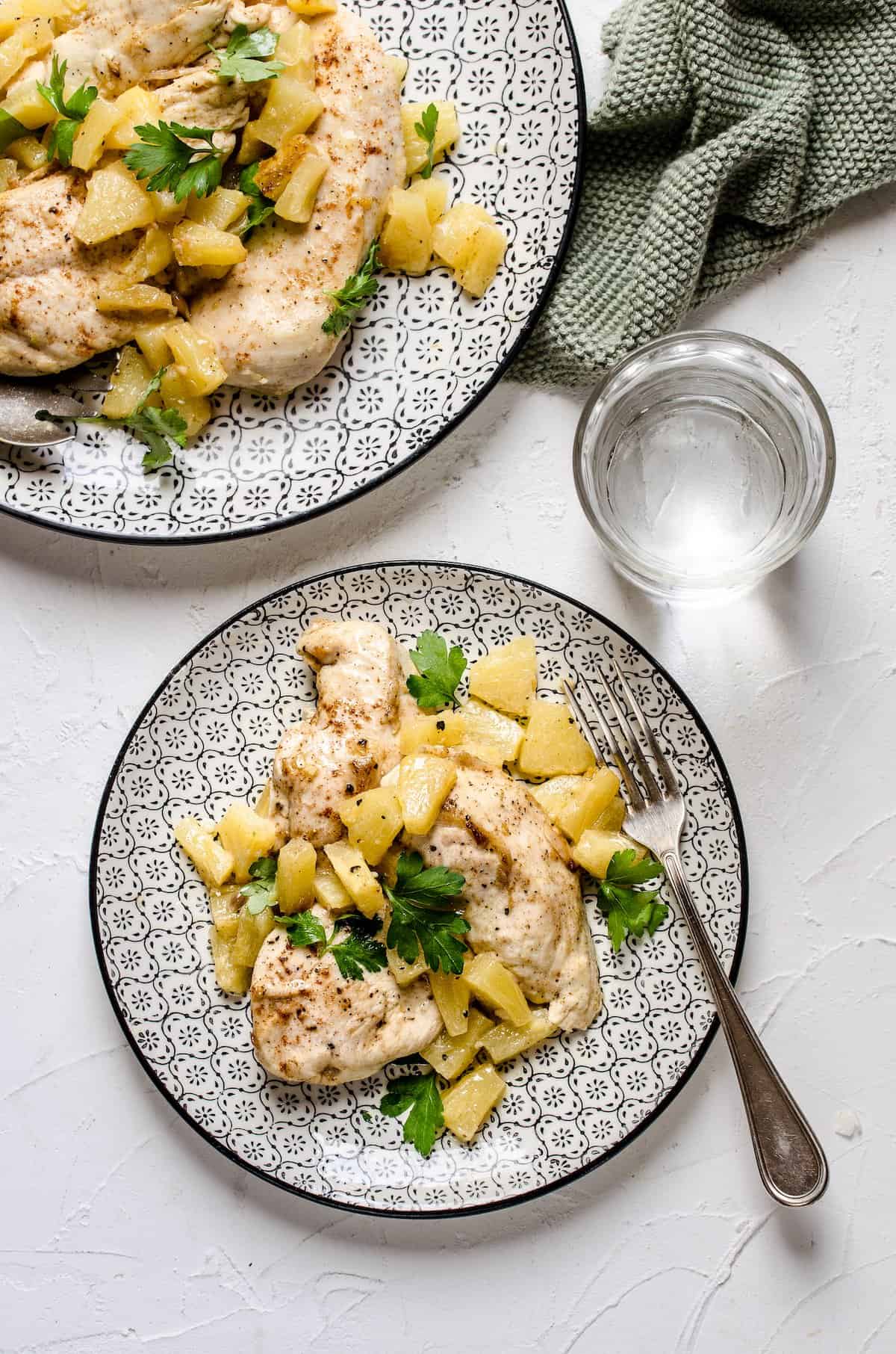 Two platefuls of Hawaiian baked chicken served with a pineapple topping.