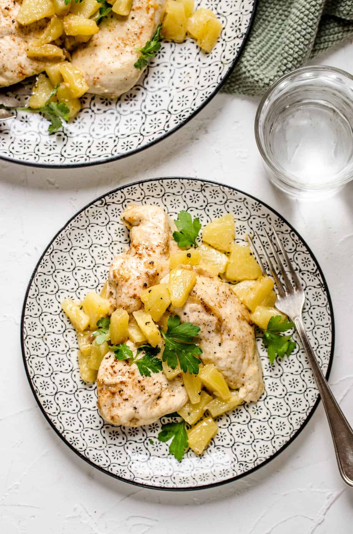 Two platefuls of Hawaiian baked chicken served with a pineapple topping.