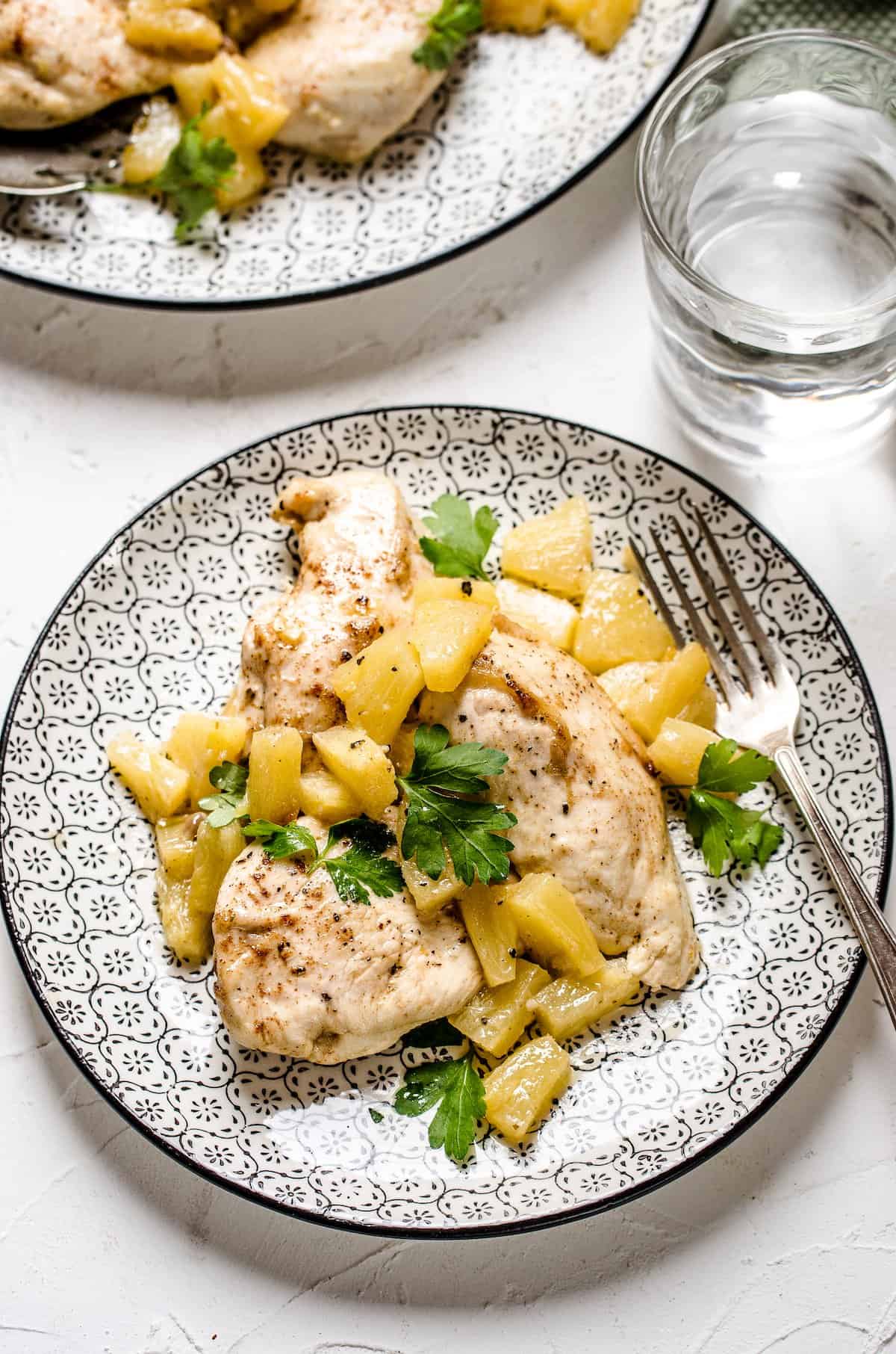 Two platefuls of Hawaiian baked chicken served with a pineapple topping.