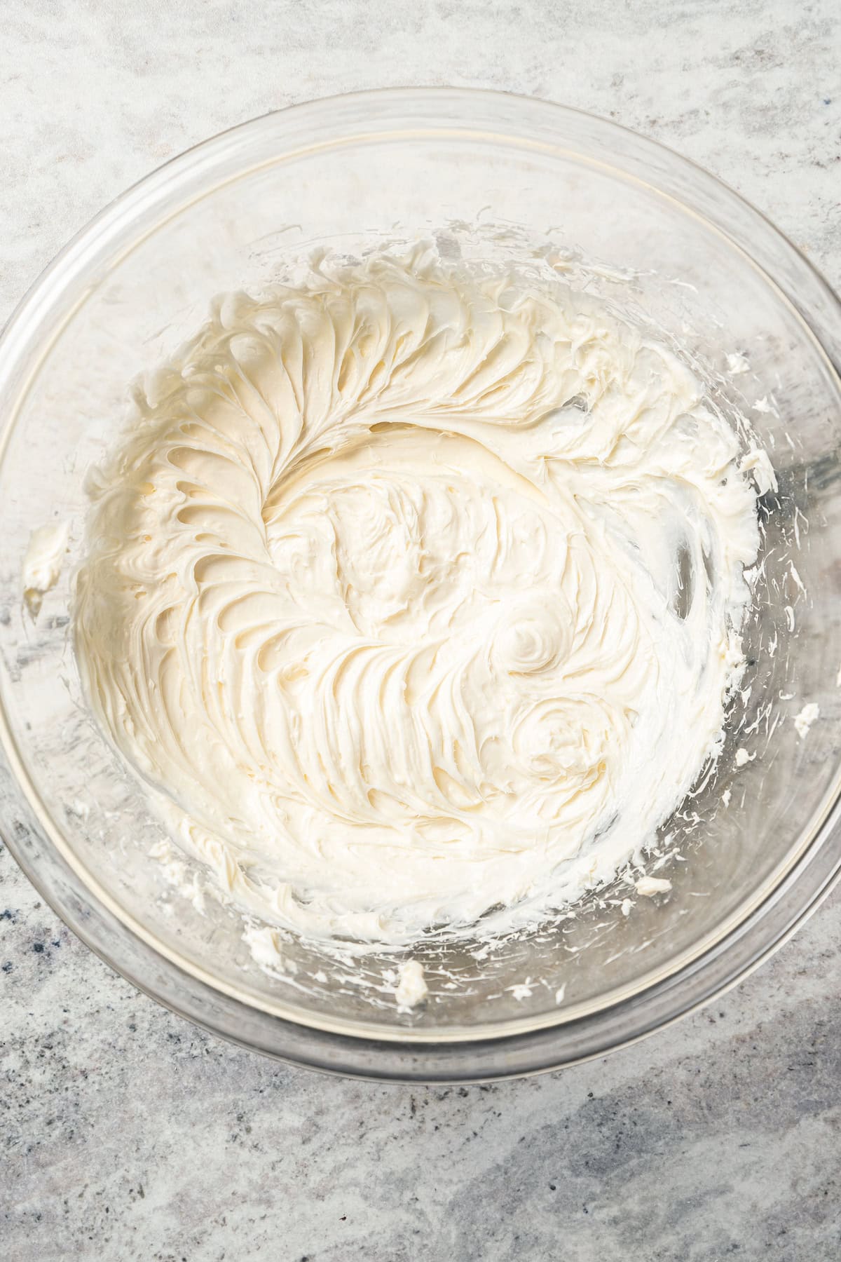 Whipped cream cheese filling in a glass bowl.