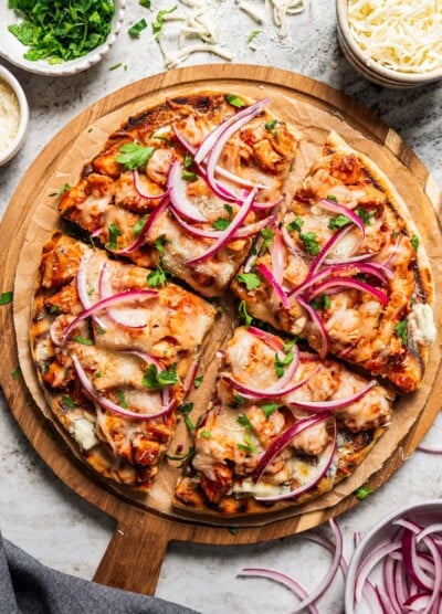 BBQ Pizza cut up into 4 slices and arranged on a serving board.