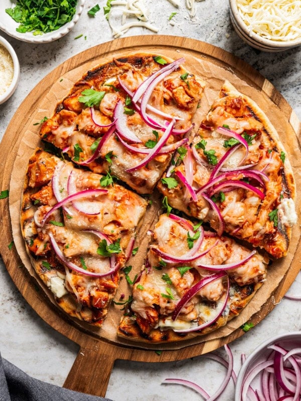 BBQ Pizza cut up into 4 slices and arranged on a serving board.