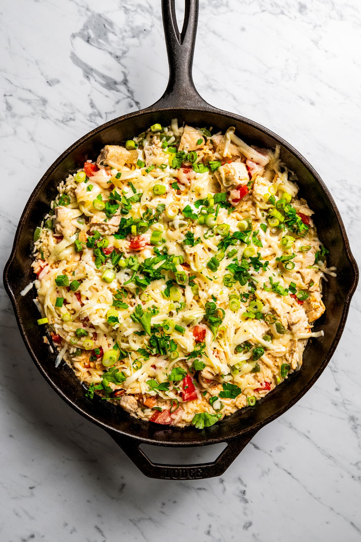Overhead image of chicken and rice in a skillet.