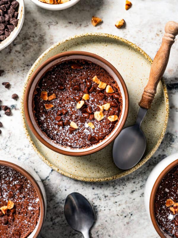 Overhead view of a chocolate souffle in a ramekin.