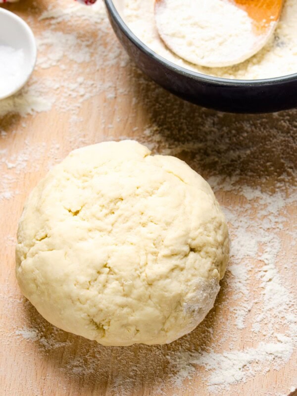 A ball of dough on a flour-dusted table.