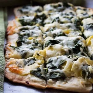 Spinach and Artichoke Dip Pizza - Homemade pizza crust topped with the best combination for dip including, cream cheese, spinach, and artichokes.