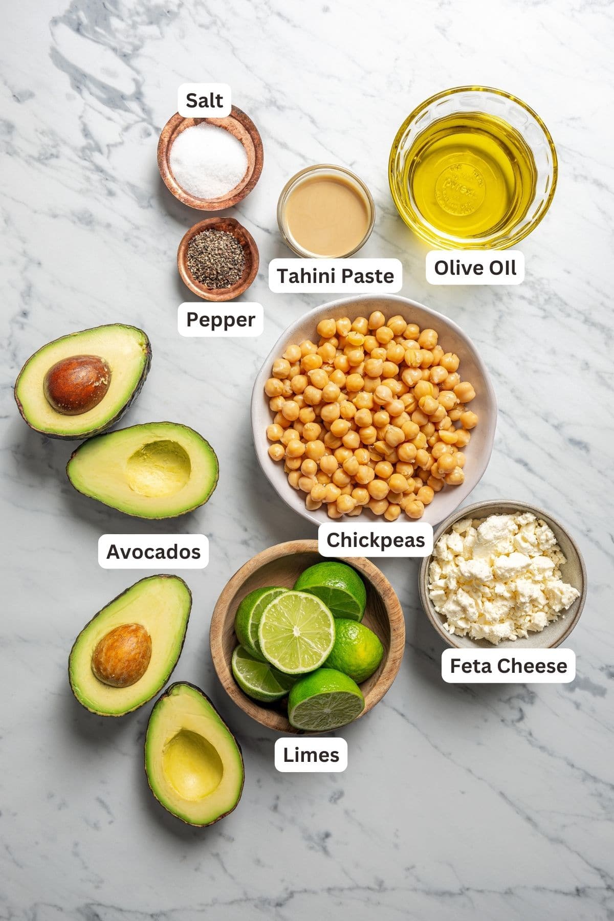 Ingredients for homemade avocado hummus with text labels overlaying each ingredient.