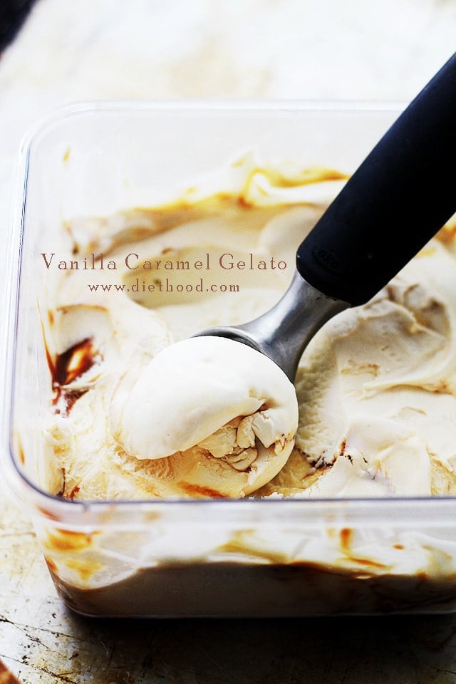 An ice cream scoop in a container of Vanilla Caramel Gelato