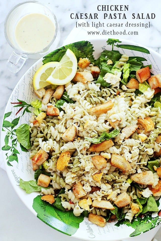 Aerial view of a bowl with Chicken Caesar Pasta Salad and a Caesar Dressing set near the bowl.