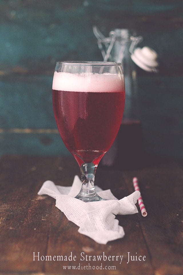 A wine glass with strawberry juice.