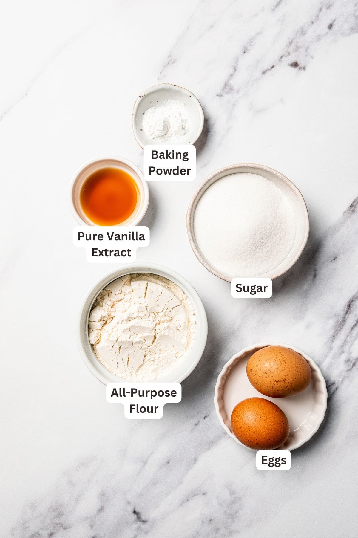 This apple pie cake has juicy caramel apples layered into a buttery crust, baked beneath a soft, sweet cake layer. It's easier than pie! Apple pie cake batter ingredients with text labels overlaying each ingredient.