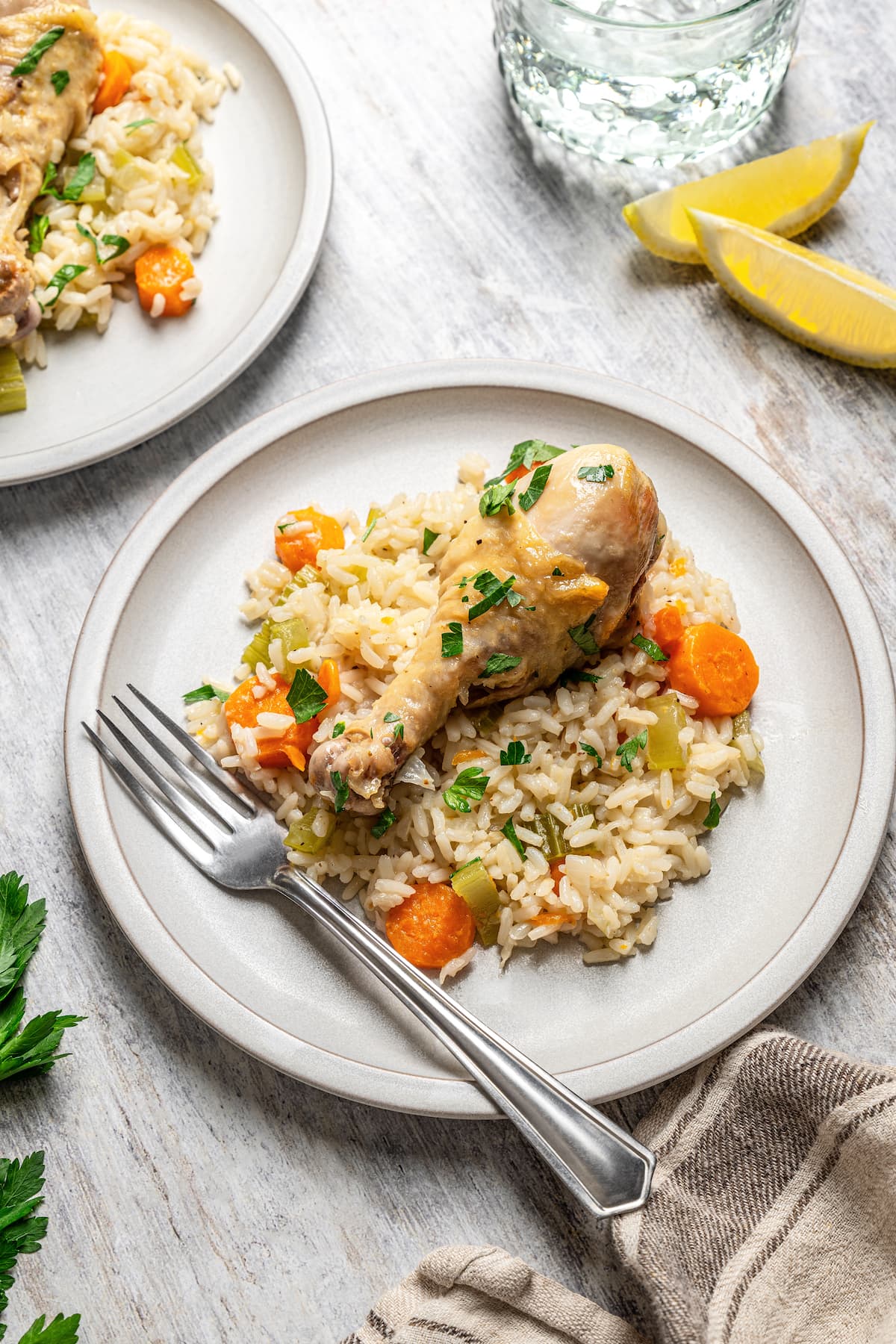 Overhead view of a serving of chicken and rice casserole on a plate next to a fork.