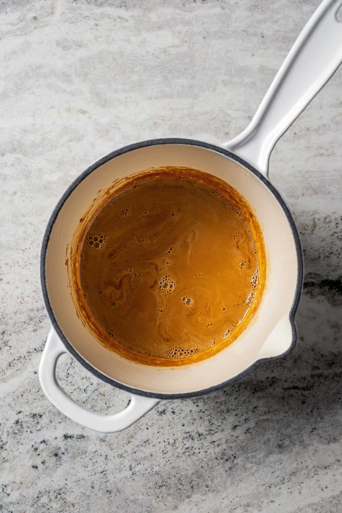 Coffee and whipping cream simmering in a saucepan.