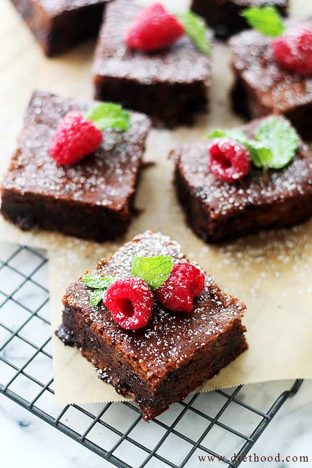 Zucchini Brownies arranged on parchment paper.