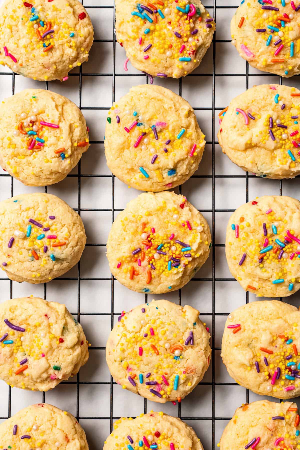 Overhead view of rows of funfetti cookies on a wire rack.