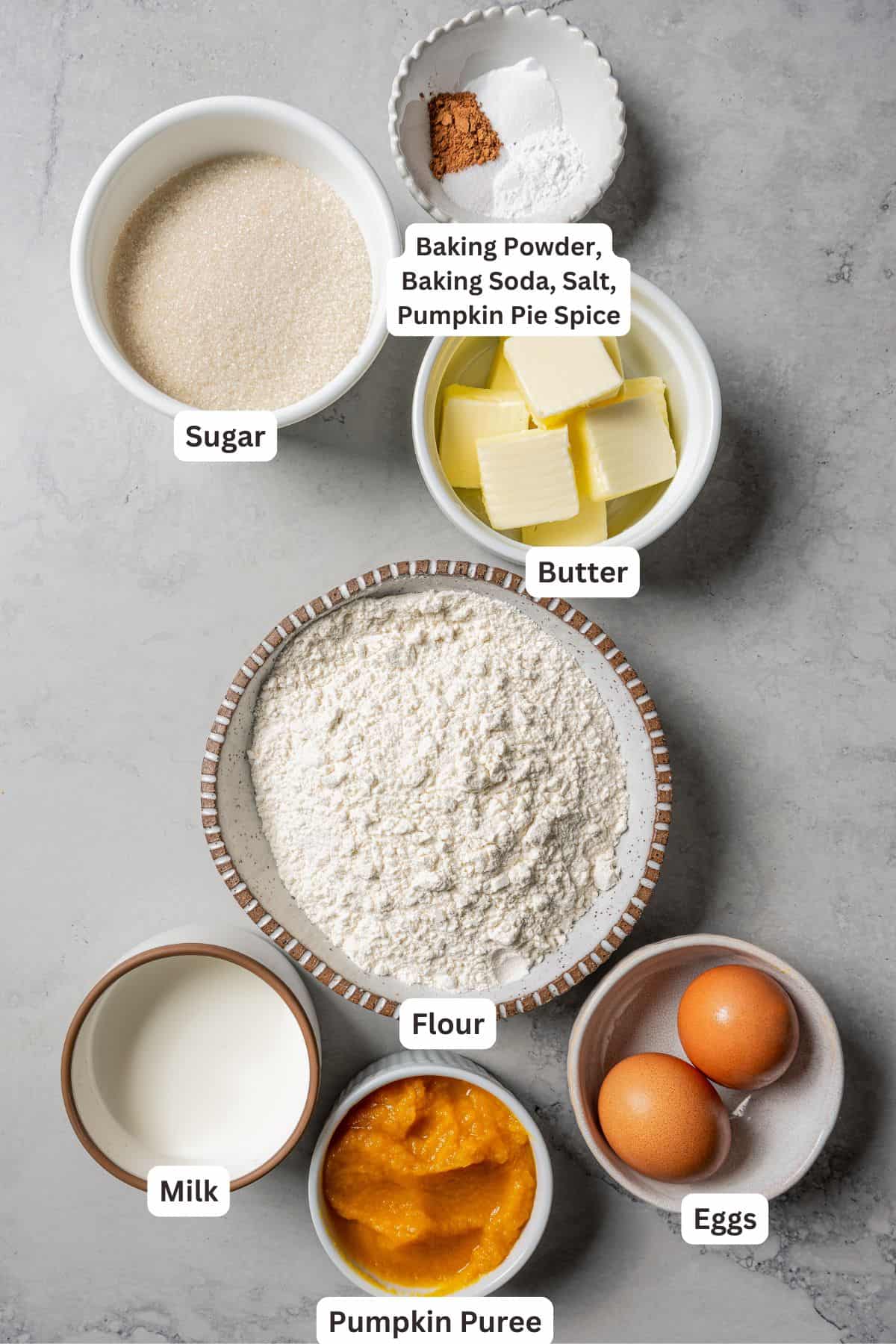 Pumpkin spice bundt cake ingredients with text labels overlaying each ingredient.