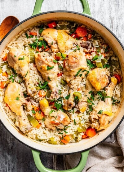 Overhead image of finished chicken and rice casserole in a large round baking dish.