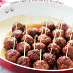 Turkey Meatballs with toothpicks in them in a red pan