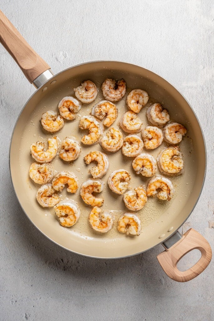 Sauted shrimp in a skillet.