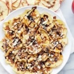 Thinly sliced apples topped with a drizzle of caramel, melted chocolate, and chopped peanuts.