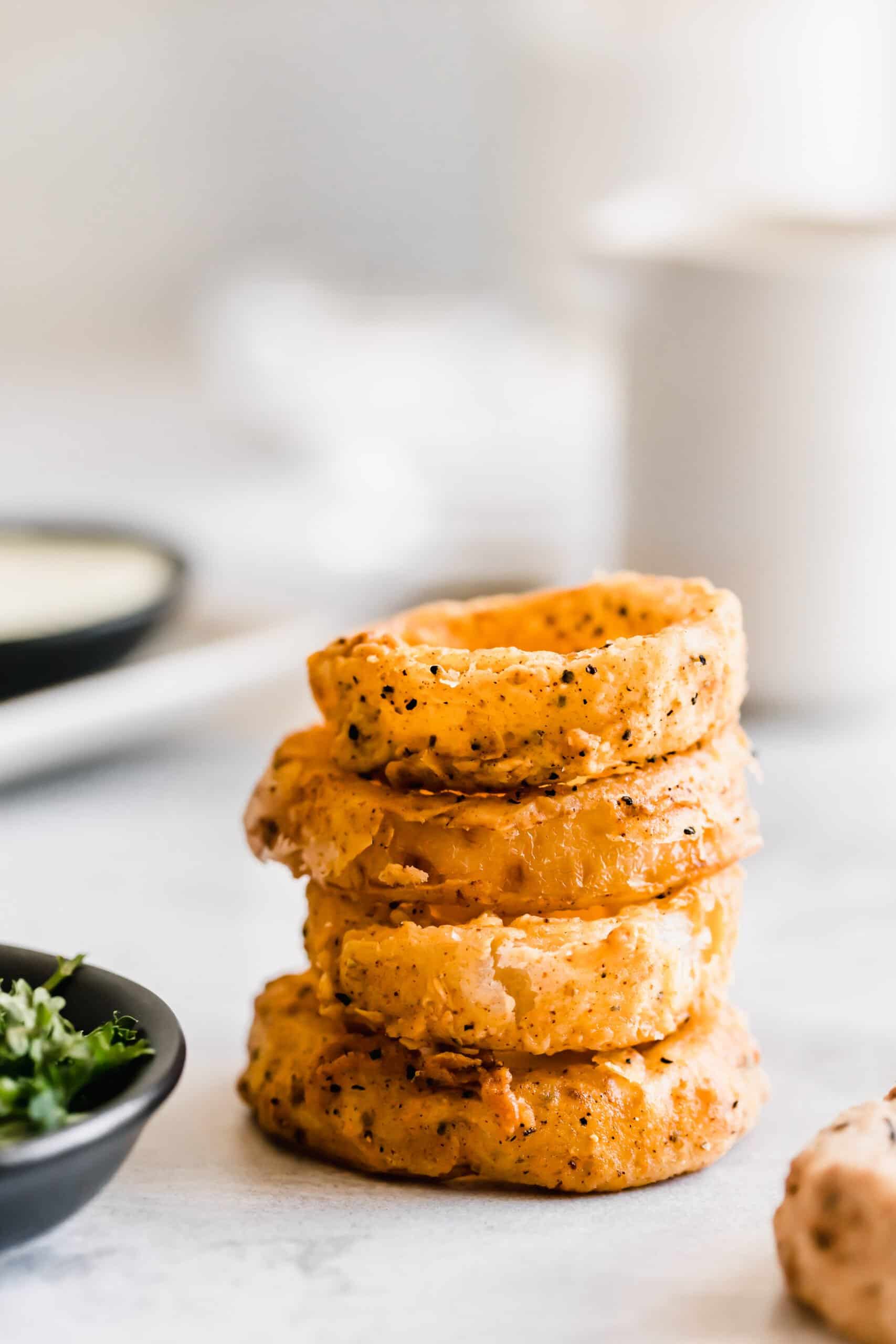 Stack of 4 homemade onion rings.