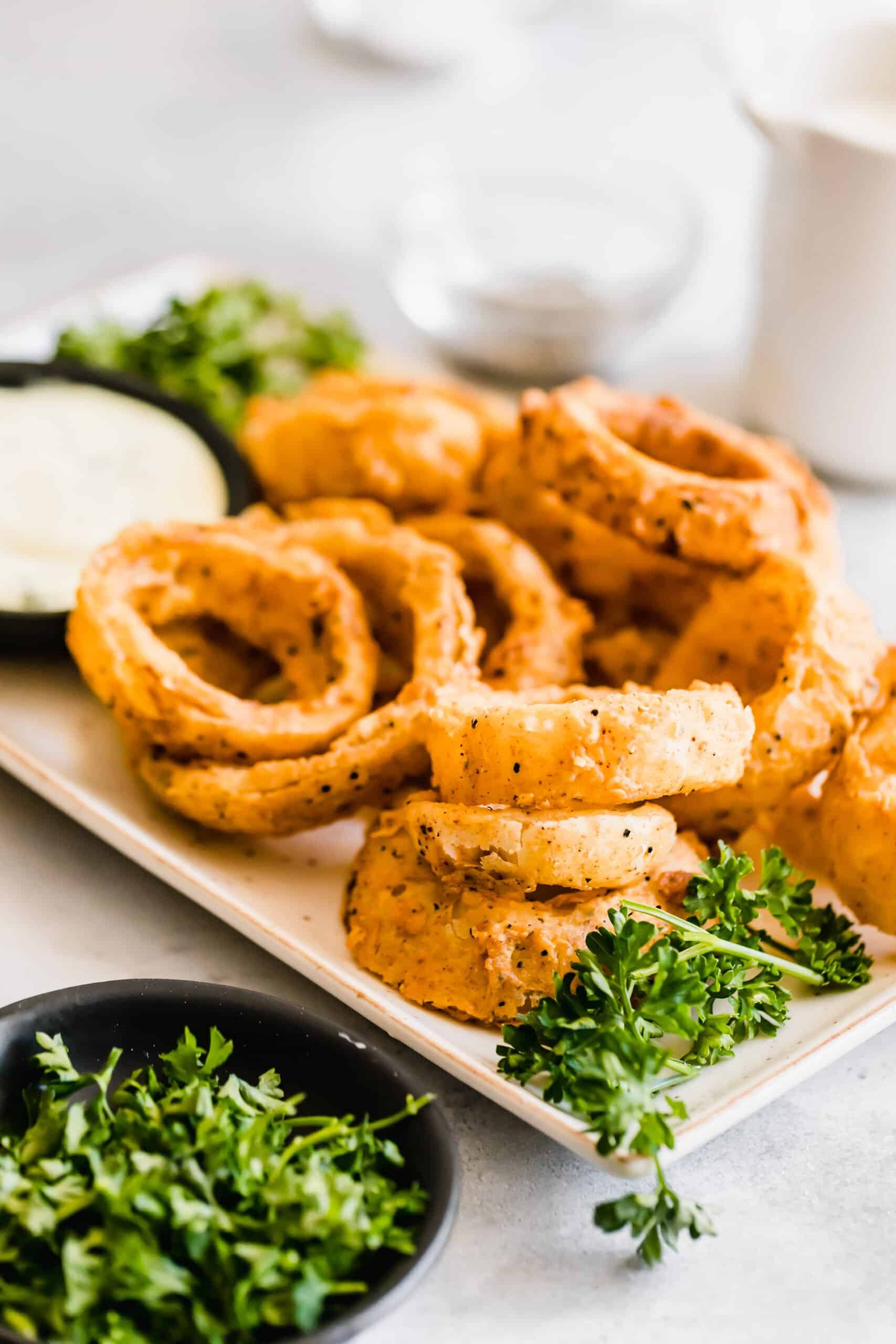 Onion rings with a bowl of dip.