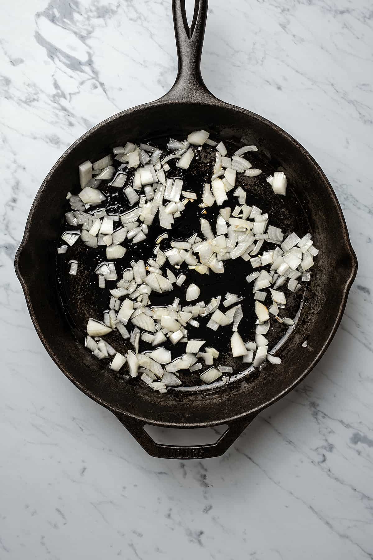 Chopped onion cooking in a skillet.