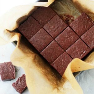 Mexican hot chocolate fudge in a pan, with few squares of the fudge arranged outside of the pan.