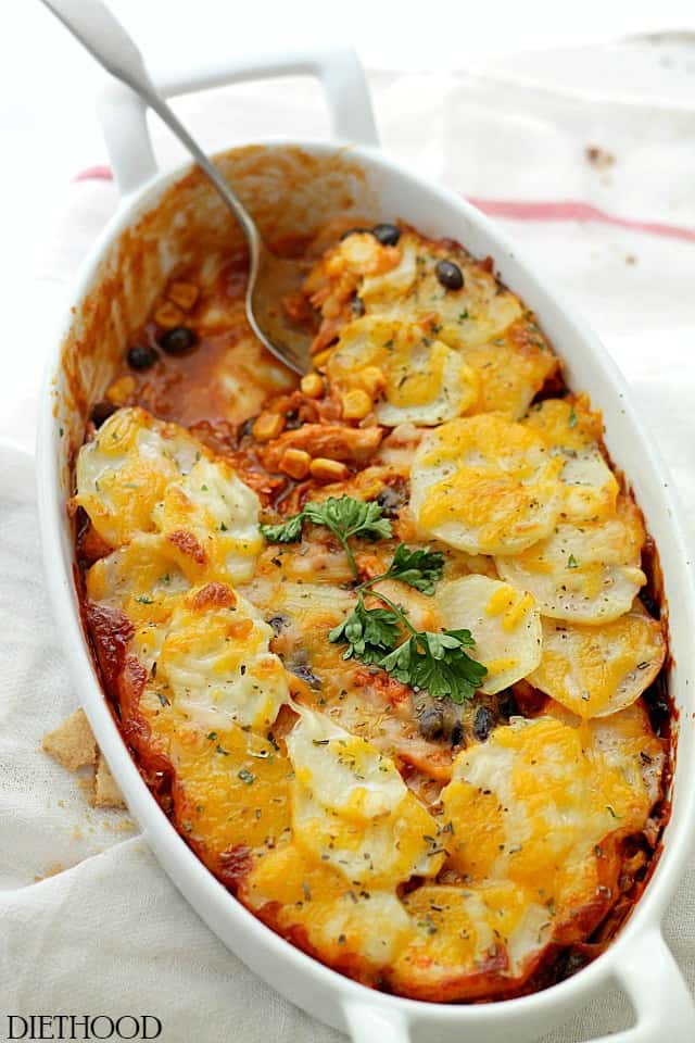 Chicken Enchilada Potato Casserole | www.diethood.com | A delicious layer of chicken, corn and black beans mixed in a beautiful enchilada sauce and topped with a layer of thin sliced potatoes.