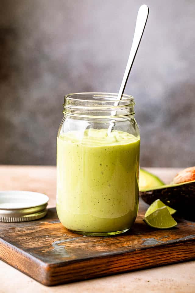 A jar filled with avocado yogurt dressing.