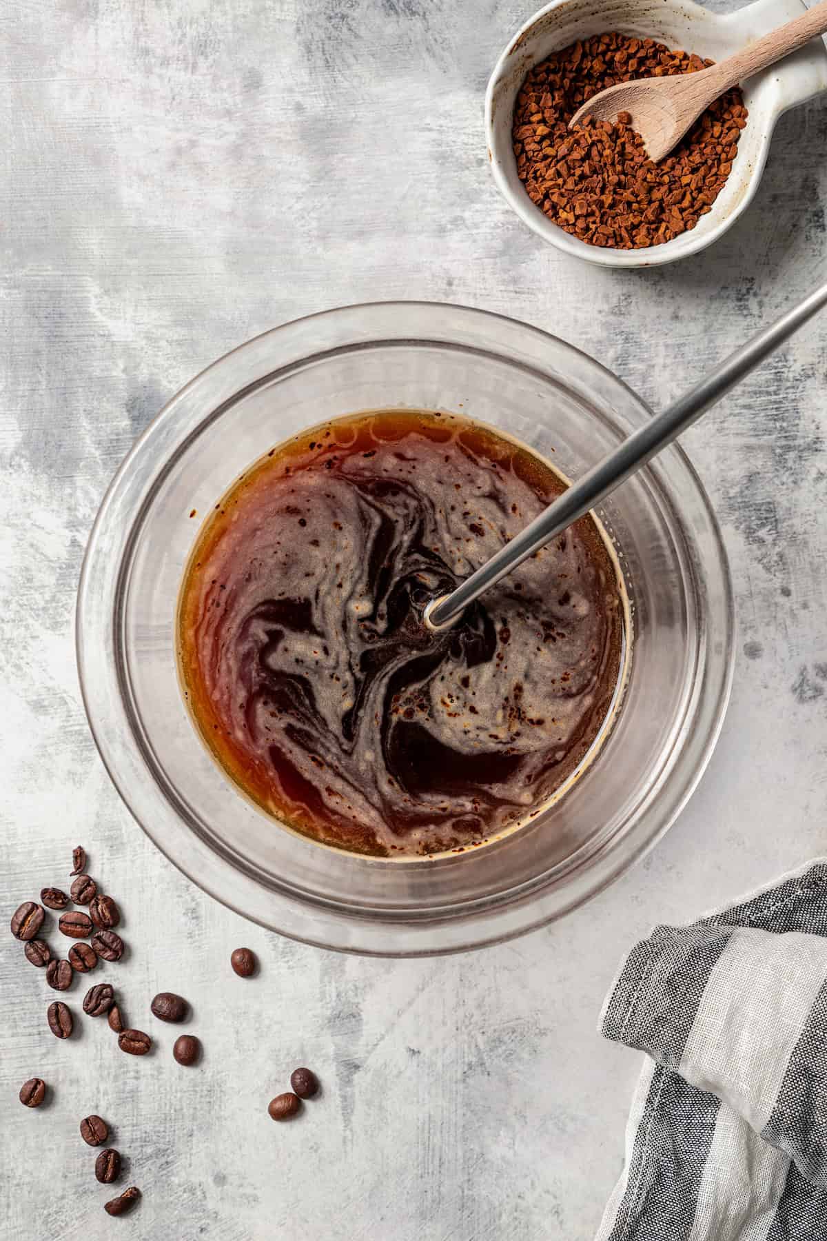 Brewed espresso whisked in a glass bowl.