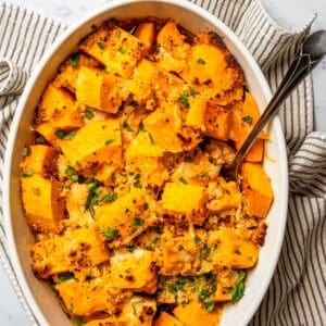 Overhead view of a baking dish with baked butternut squash.