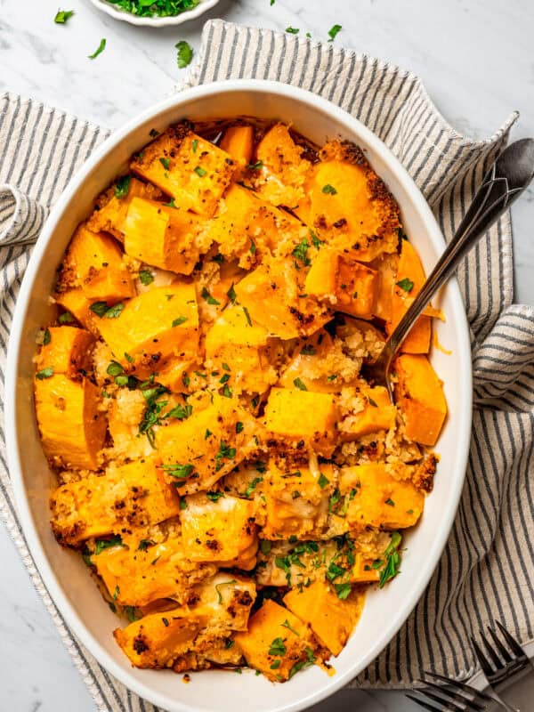 Overhead view of a baking dish with baked butternut squash.