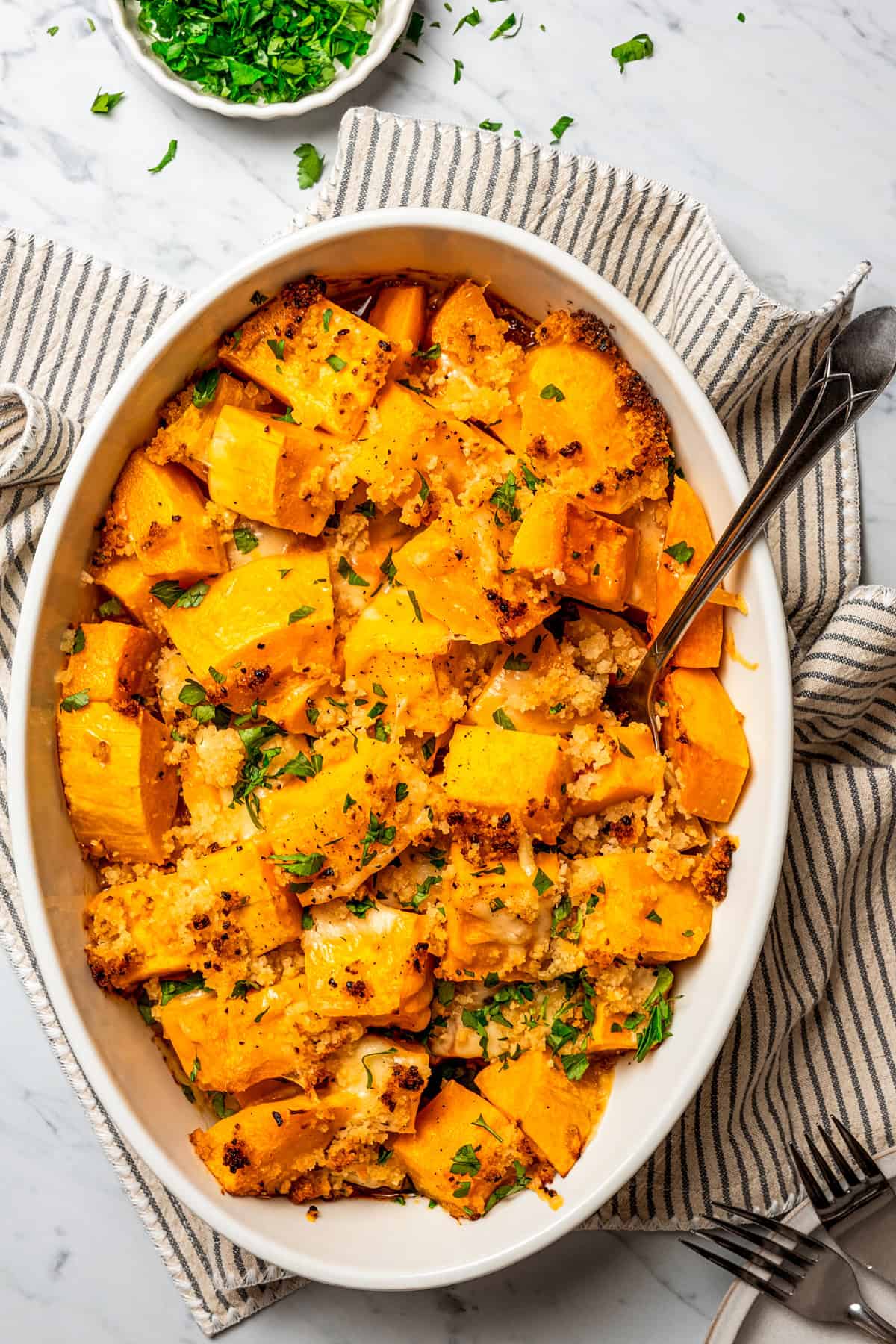 Overhead view of a baking dish with baked butternut squash.