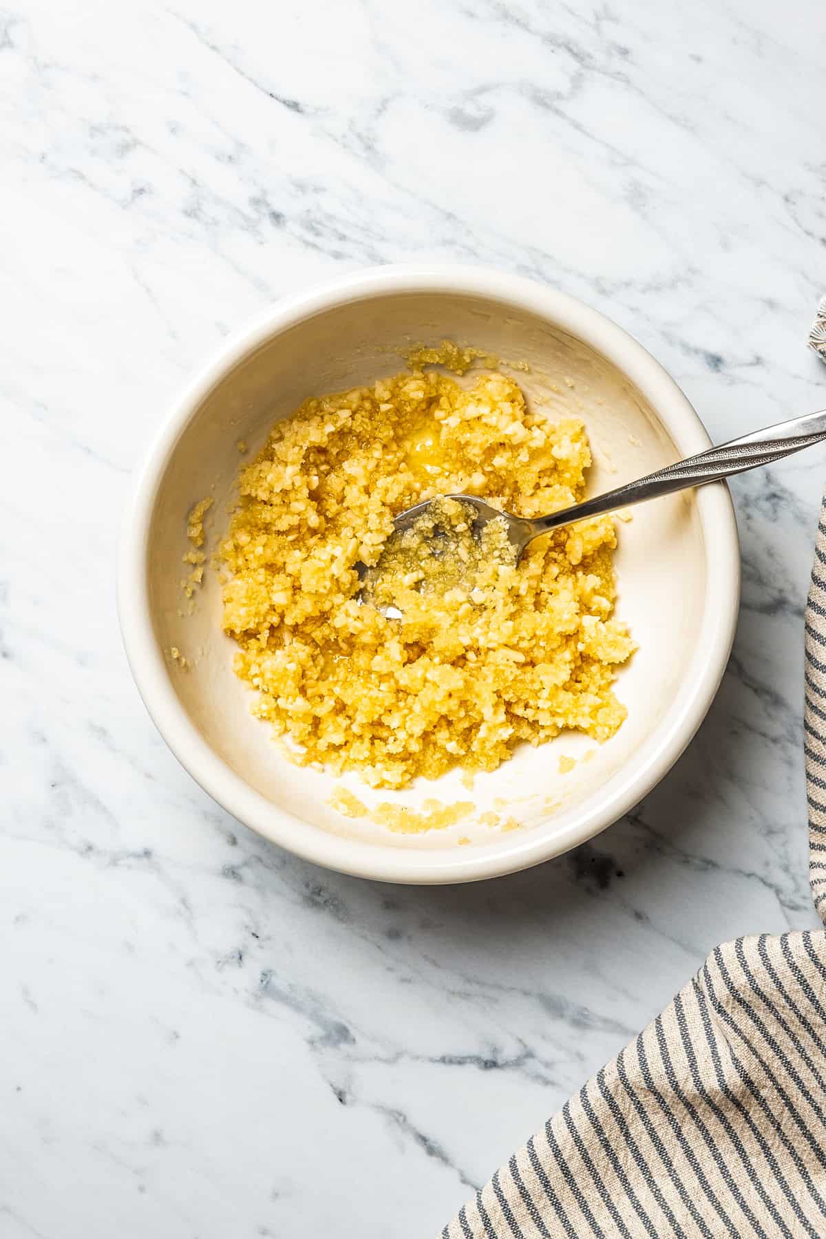 A small bowl with minced garlic.