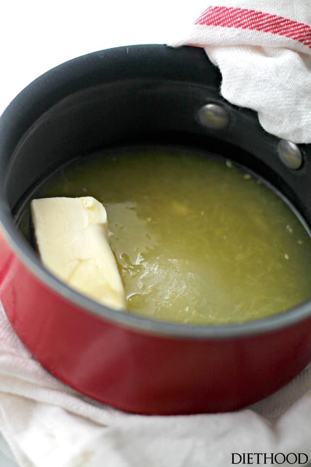 Butter being melted together with sugar and orange juice in a saucepan for the orange glaze.